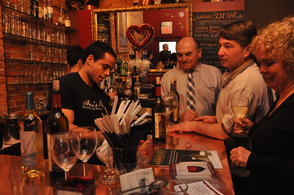 Attendees including Richard Vohden and Lou Tommaso, sample the event foods, and wines.