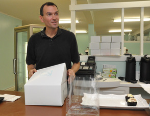 Chip Schaffer boxes up some cupcakes.