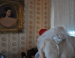 A portrait of Britta M. (Cooper) Carnahan overlooks her wedding gown from 1871 inside the museum.