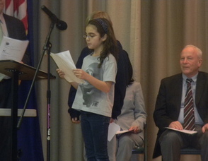 A fifth grade student reading a poem about eating helathy
