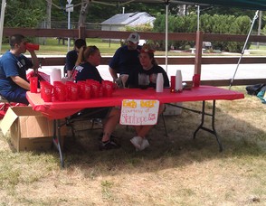 Members of the Stanhope Fire Department give away free birch beer to the residents.