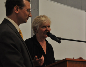 Samuel Burlum presents a donation to Sandy Mitchell of the Spirit of the Arts Foundation.