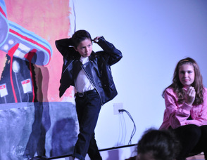 Danny struts onto the scene, combing his hair.