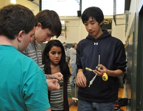 New Providence High School students working on their car prior to racing.