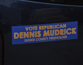 A bumper sticker on a car outside of The Dining Room.