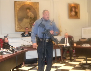 Madison Patrolman Kevin Boone demonstrating how assault weapons are used