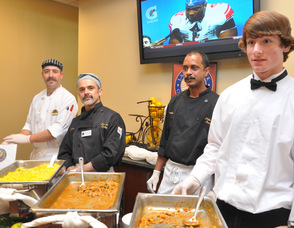 Sean Hutchinson, Jake Dominguez, Francis Fernandez, and Adre Dirle prepared Asian Style Shrimp with vegetables, Chicken Marsala, Saffron Rice, and Chick Peas.