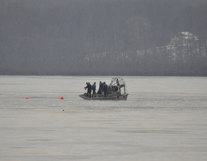 The police work on location after laying down buoys.