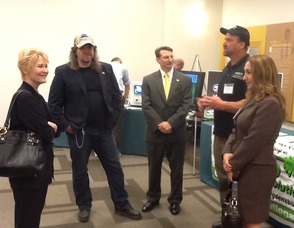 Dee Wallace, the event's celebrity emcee, visits the Extreme Energy Solutions booth and speaks with Dan Hollis, Samuel K. Burlum, Phil Sermin, and Nermin Ucar.