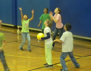 kids throwing balls at the pins