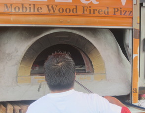 making pizza in the wood oven
