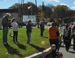 Spectators wave to parade participants.