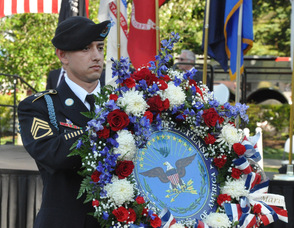 Matthew D. Neuenfeldt, Army Staff Sergeant, carries the Military Wreath.