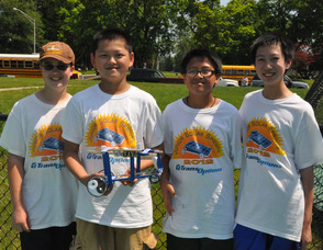 Ben Homa, Jonathan Hua, Nikko Pangasnan, and Sean Yu with "Ying Yang". The students are from Allen W. Roberts Elementary School. 