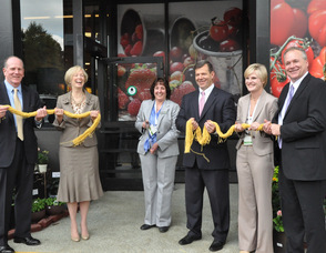 General Store Manager Carole Bracaglia cuts the "ribbon" of spaghetti, inviting shoppers to the new kings Food Market in Livingston.