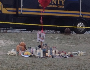 Candles still burn from yesterday evening, at the site of the memorial set up for a pair of Mount Olive teenagers.