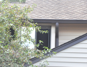 One of the windows removed by the fire department, where flames had previously been, on the second floor of 39 Eagle Drive.