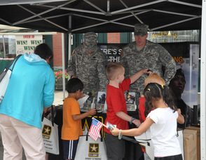Members of the U.S. Army answer questions for visitors to their booth.