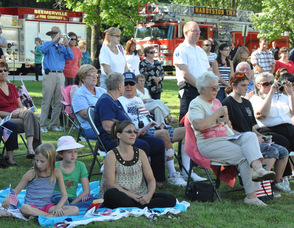 The audience listens to "America the Beautiful".