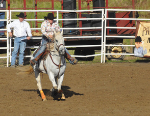 A participant and her horse during barrel racing.
