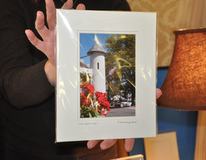 Deborah Dewey holds up a photo from Daniel Baumgartner of 35mmphotos, which made the cover of the CenturyLink phone book.