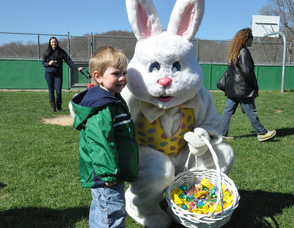 Alex Robinson, age 2, smiles and poses with the Easter Bunny in Andover Township.