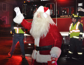 Santa waves after descending from Tower 804.
