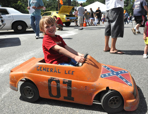 Steve Wronka, age 7, drives around Franklin Sussex Auto Mall in his mini General Lee.