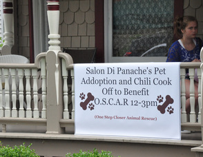 The sign for the chili cook off draped on Salon Di Panache's front porch.