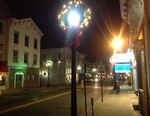 A view of Newton's Spring Street at night, with its holiday lights.