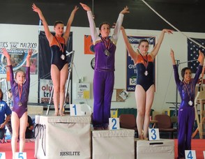 Kayla Komnath in 1st and Lia McAuliffe in 3rd on Uneven Bars.