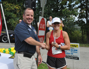 Melissa Fagersten smiles as she accepts her trophy.