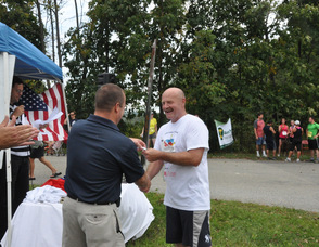 Undersheriff Keith Armstrong receives his ribbon from Sheriff Michael Strada.