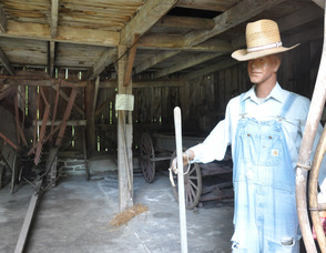 Hay fork belonging to Job Clark (1930), and a wooden wagon from 1910, sit in the Wagon House, circa 1787.