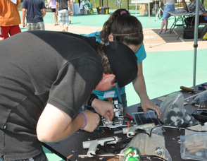 Students repair their vehicle at the East Coast Alternative Energy repair table.