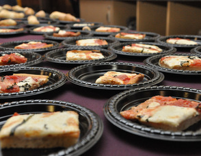 "Grandma Pie", a thin crust pizza, lined up at The Dining Room's table.