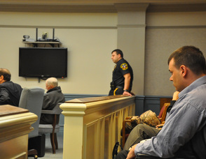 Scott Harris overlooks the courtroom, and Michael Stabile.
