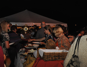 Guests enjoy the buffet by moonlight.