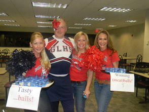 Detective Joe Williams of the Berkeley Heights PD dressed  as a cheerleader with his wife and volunteers