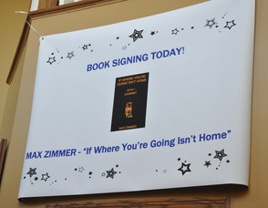 Sign greeting Max Zimmer at the book signing event.
