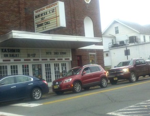 Cars wait outside of The Newton Theatre, while gridlock prevailed at the intersection. Some drivers impatiently made hand gestures at other drivers in front of them. The marquee of The Newton Theatre, was visibly also missing some letters, courtesy of Hurricane Sandy.