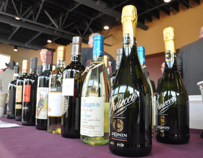 A variety of wines line the table.