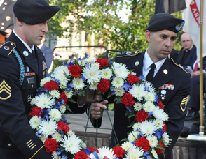 John Flynn, and Juan Maldonado carry the Fallen Military wreath.
