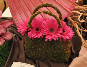A bridesmaid's bouquet created by Brookside Florist, sits in an ivy purse.