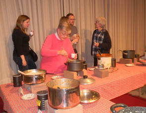 People sampling soup