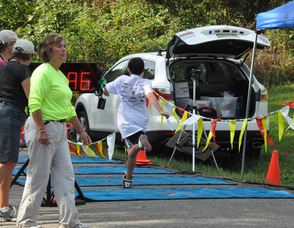 A young participant crosses the finish.