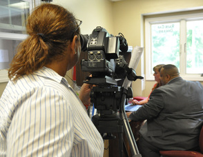 Zaida Collazo filming Ron Gaines, Patricia Singer, and Rosanne Turkington.