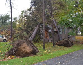 This East Shore Trail home was struck with two large Trees.  15 Homes have either moderate or extensive damage as a result of fallen trees.  (Sparta Township Police Photo).