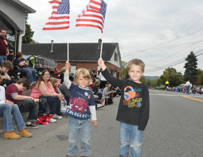 Alex and Evan Garrett, ages 5 and 3, of Hackettstown, wave flags for parade participants.