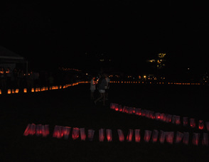 Participants stand among a sea of luminarias.